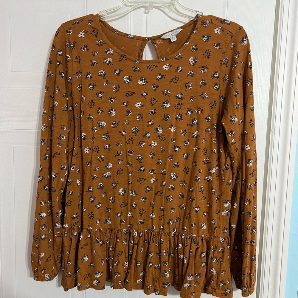 A soft, light, ruffled, orange, floral, long sleeved shirt